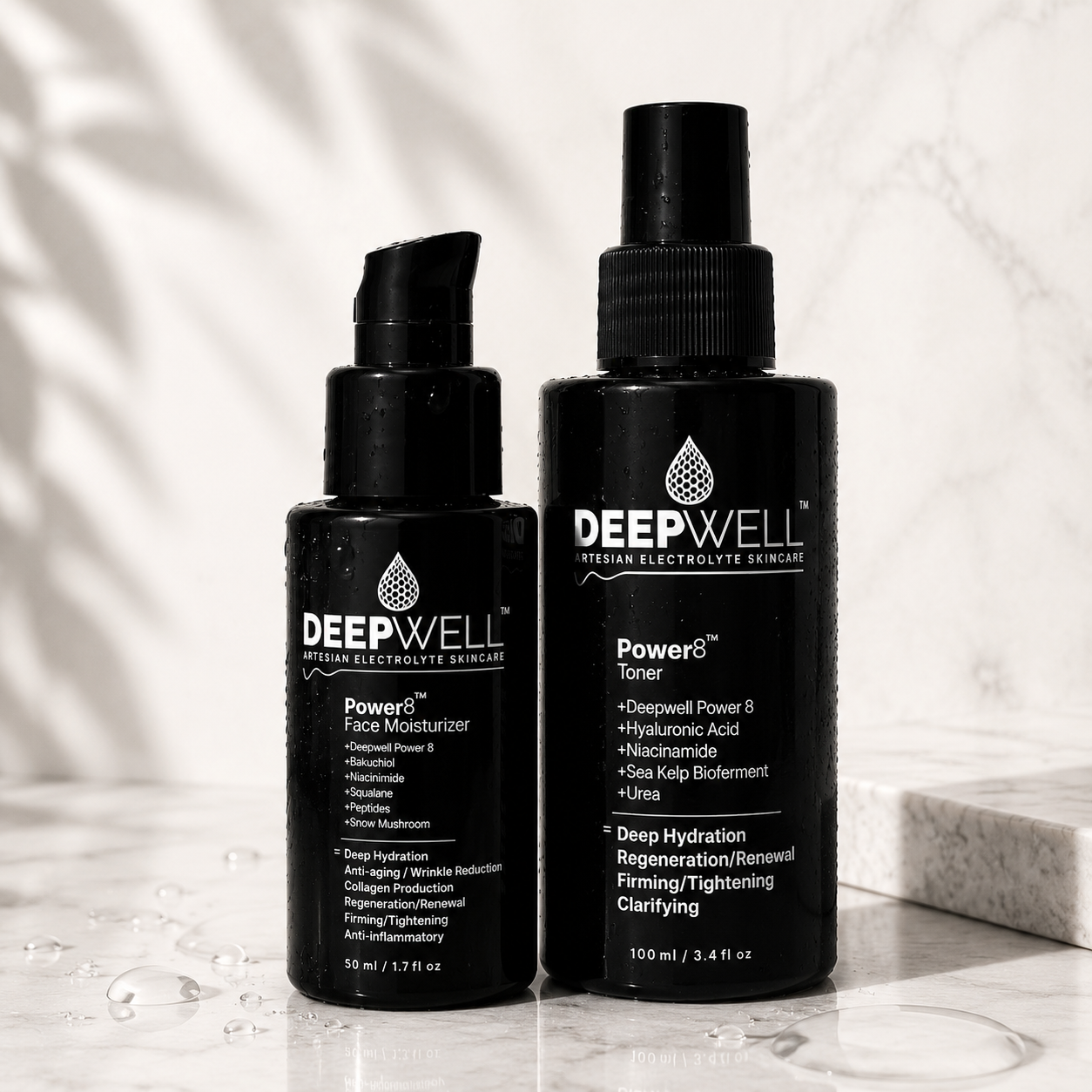 Two black-violet skincare bottles from Deepwell Skin & Beauty, including Power Face Moisturizer and Power Toner, displayed on a white marble surface with soft leaf shadows.